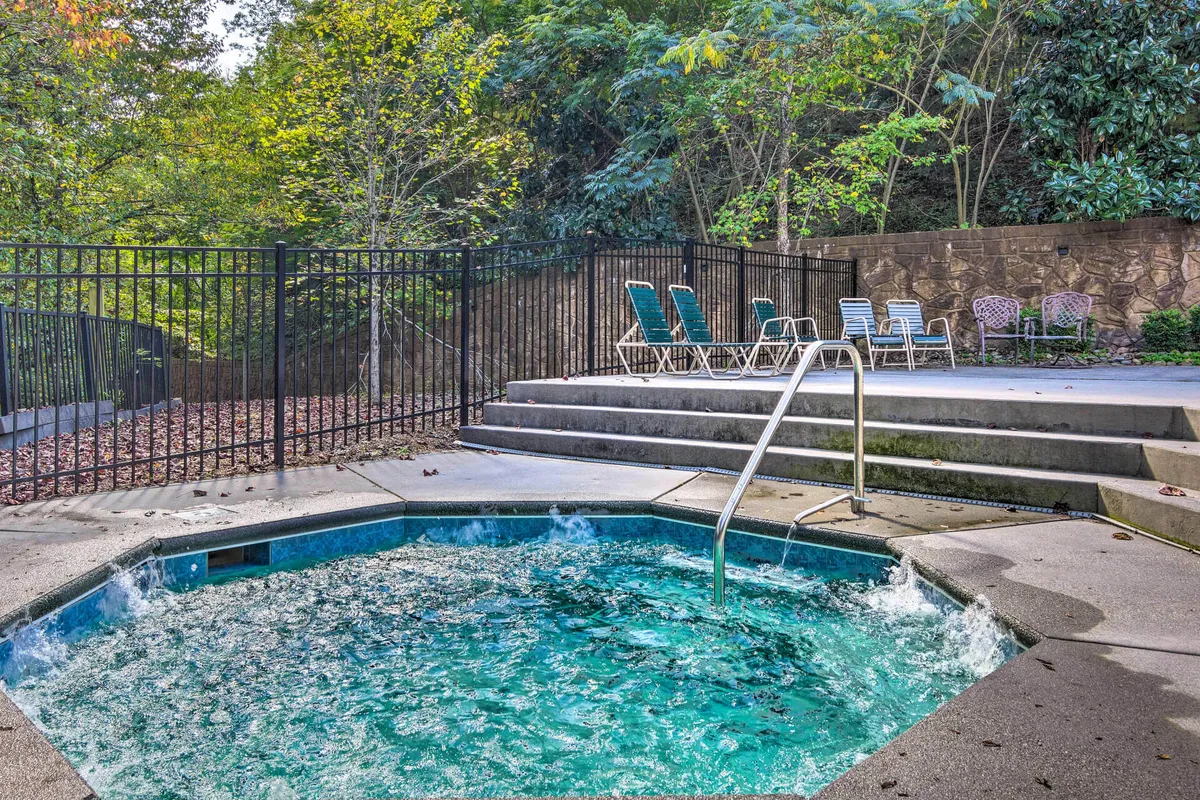 An outdoor hot tub with lounge chairs is nestled among lush greenery, providing a tranquil spot to unwind after a day of exploring. The setting offers privacy and connection to nature, ideal for relaxing evenings.